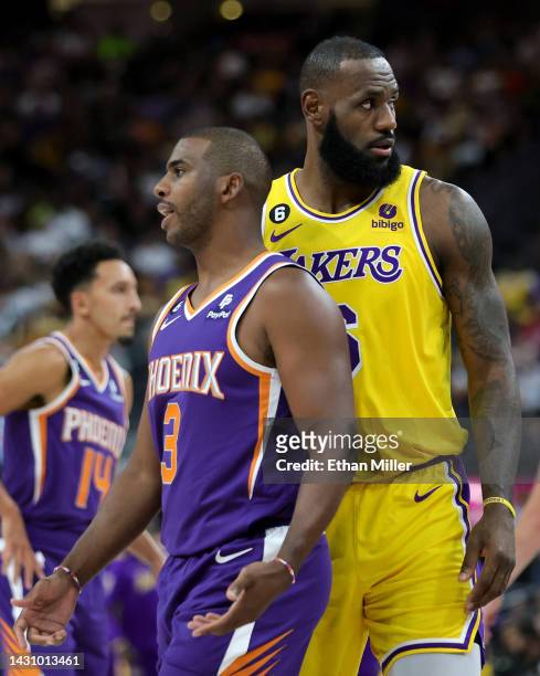 Chris Paul of the Phoenix Suns and LeBron James of the Los Angeles Lakers stand on the court during a break in the second quarter of their preseason...