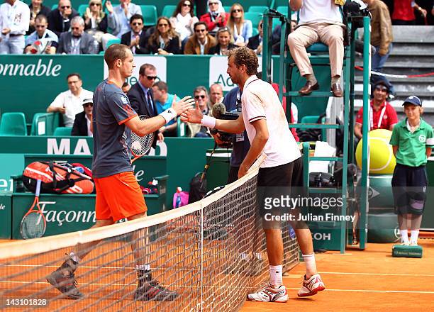 Andy Murray of Great Britain shakes hands with an injured Julien Benneteau of France as he retires from the match during day five of the ATP Monte...