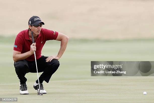 Nicolas Colsaerts of Belgium lines up a putt during the first round of the Volvo China Open at the Binhai Lake Golf Course on April 19, 2012 in...