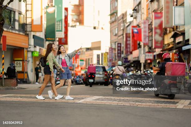 two women traveled independently on tamsui old street in taipei in summer - taipei bildbanksfoton och bilder