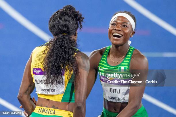 Elaine Thompson-Herah of Jamaica after winning the gold medal in the Women's 200m Final is congratulated by silver medal winner Favour Ofili of...