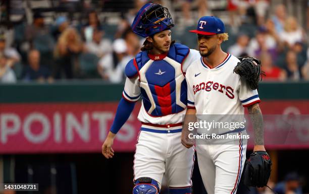 Jonah Heim of the Texas Rangers and teammate Yerry Rodriguez walk to the team dugout following Rodriguezs pitching outing against the New York...