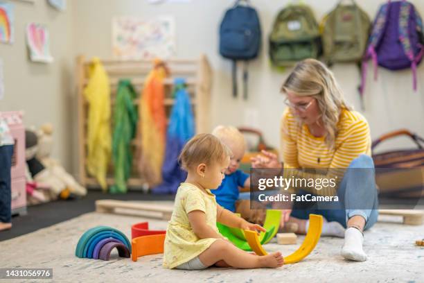 infant time at daycare - puériculture stock pictures, royalty-free photos & images