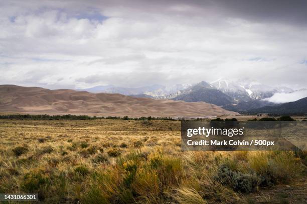 scenic view of field against sky,great sand dunes,colorado,united states,usa - mark colvin stock pictures, royalty-free photos & images