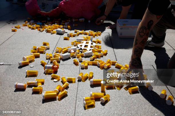 Empty pill bottles from a piñata are scattered on the sidewalk during a protest against the price of prescription drug costs in front of the U.S....