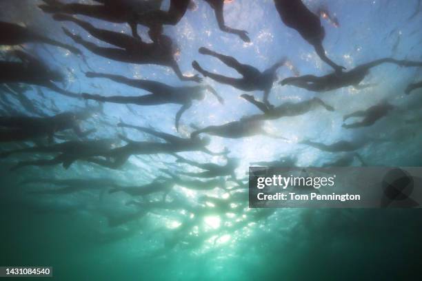 Athletes compete in the swim portion during the Ironman World Championships on October 06, 2022 in Kailua Kona, Hawaii.