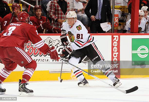 Marian Hossa of the Chicago Blackhawks skates with the puck against the Phoenix Coyotes in Game One of the Western Conference Quarterfinals during...