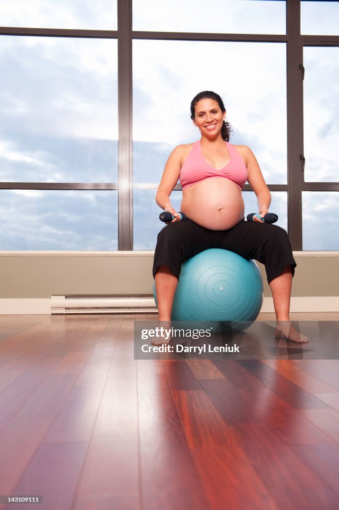 Pregnant Hispanic woman exercising