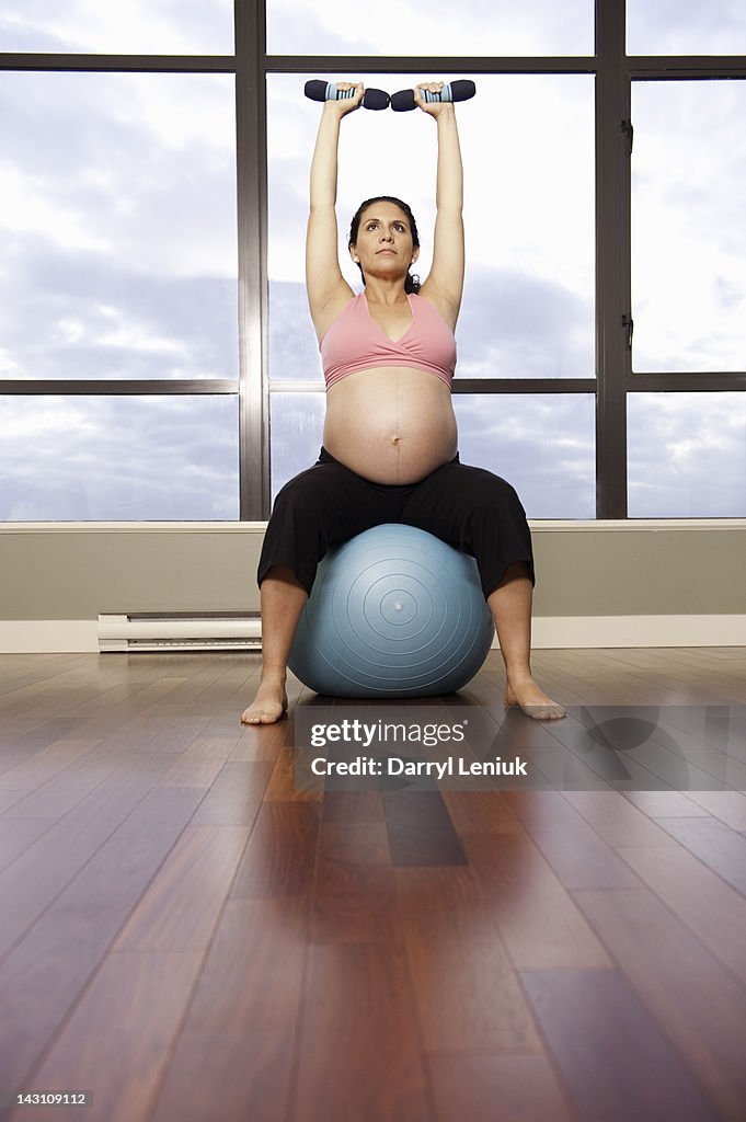 Pregnant Hispanic woman exercising