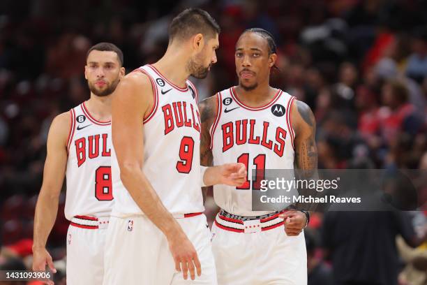 Zach LaVine, Nikola Vucevic and DeMar DeRozan of the Chicago Bulls look on against the New Orleans Pelicans during the first half of a preseason game...