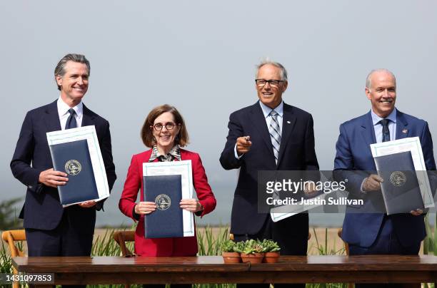 California Gov. Gavin Newsom, Oregon Gov. Kate Brown, Washington Gov. Jay Inslee and British Columbia Premier John Horgan hold up signed climate...