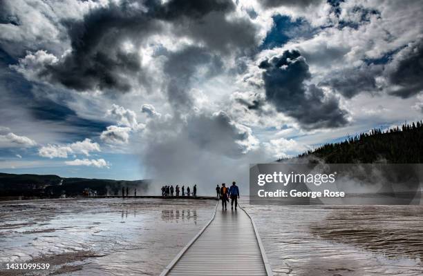 Visitors walk along a boardwalk at the iconic Grand Prismatic Spring in Yellowstone National Park's Midway Geyser Basin on September 18 in...