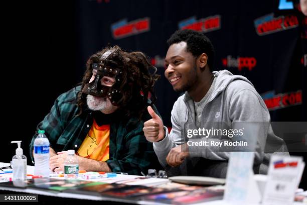 Mick Foley poses with a guest during New York Comic Con 2022 on October 06, 2022 in New York City.