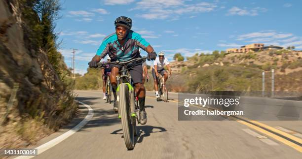 black mountain biker riding on the road - california state route 58 stock pictures, royalty-free photos & images