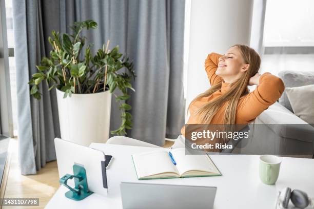 young woman with hands behind head, taking a break from work - connected mindfulness work stock pictures, royalty-free photos & images