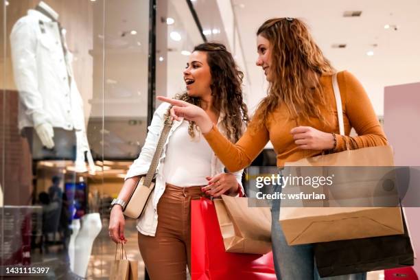 two women making shopping. - winkelcentrum stockfoto's en -beelden