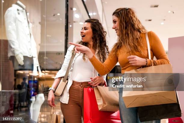 two women making shopping. - shopping mall stockfoto's en -beelden