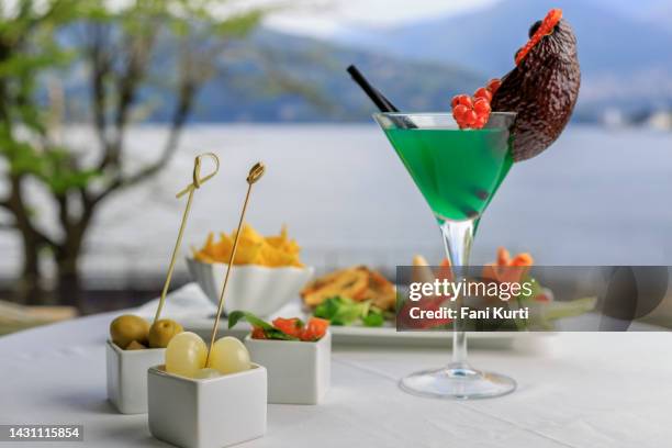 cocktails and finger food aperitif by the lake - garda stock pictures, royalty-free photos & images