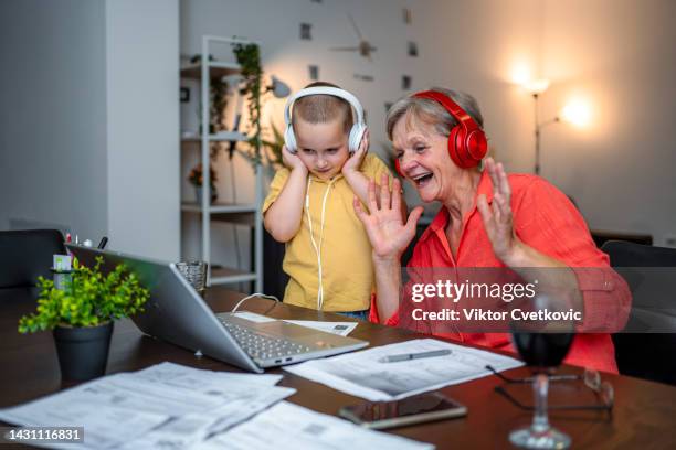 little grandson helping his grandmother with home finance - grandma invoice stock pictures, royalty-free photos & images