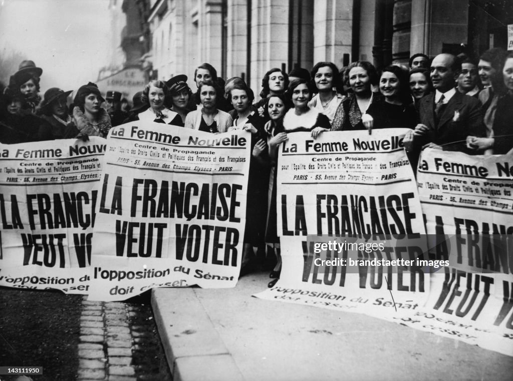 Young French feminists demonstrate with the posters that state: "French Women want to vote". Paris. Photograph. Around 1935.
