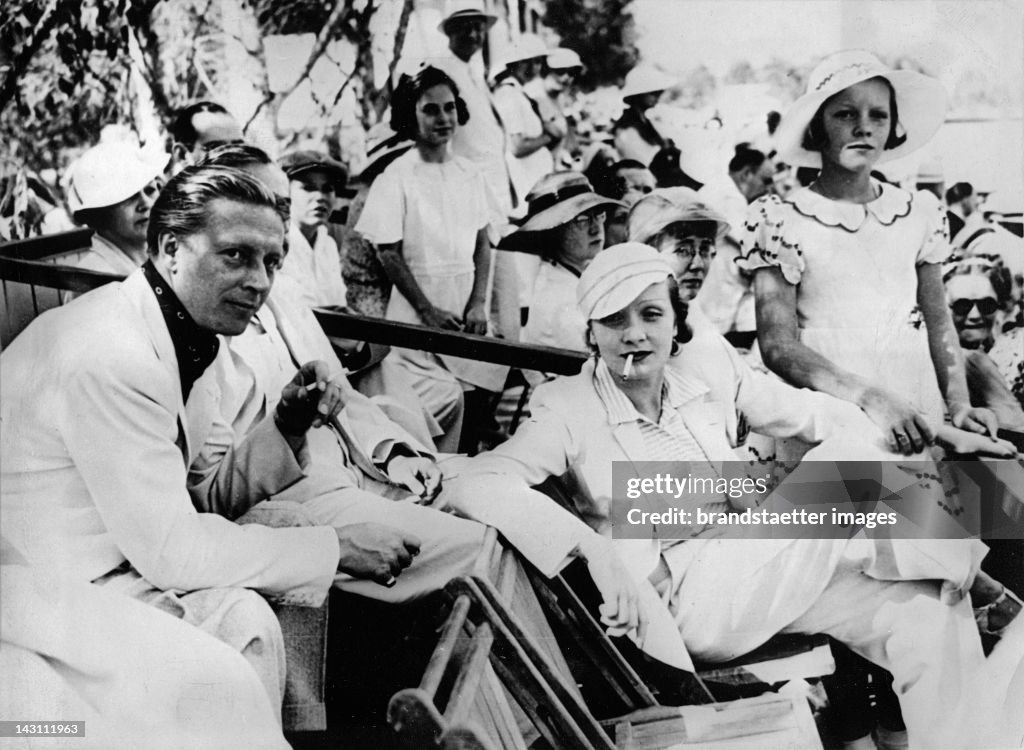 Marlene Dietrich, her daughter Maria and her husband Rudolf Sieber watching a Polo game. Los Angeles. Photograph. About 1935.