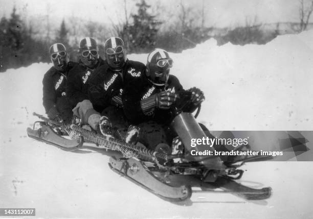 The Bobsleigh team of Sarane equipped with iron masks shortly before the Winter Olympics in Lake Placid. USA. Photograph. 1932.