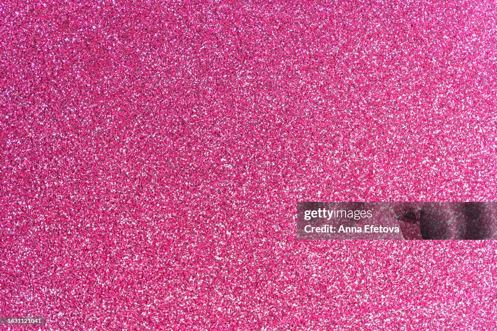 Festive pink glittering background. New Year and Christmas celebration concept. Bright backdrop for your design with copy space