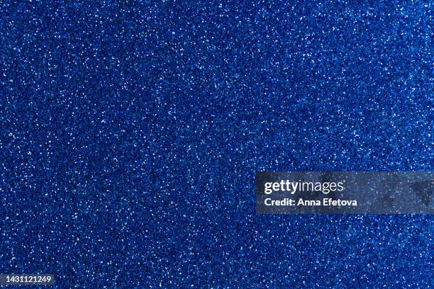 festive navy blue glittering background. new year and christmas celebration concept. bright backdrop for your design with copy space. - navy blue stockfoto's en -beelden