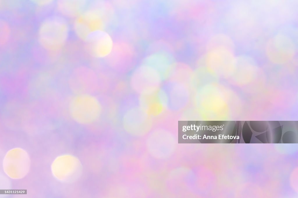 Festive defocused holographic glittering background. New Year and Christmas celebration concept. Bright backdrop for your design with copy space. It's also can be perfect background for birthday and carnival
