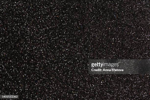 festive black glittering background. new year and christmas celebration concept. bright backdrop for your design with copy space. it's also can be perfect background for black friday sales. - purpurina fotografías e imágenes de stock