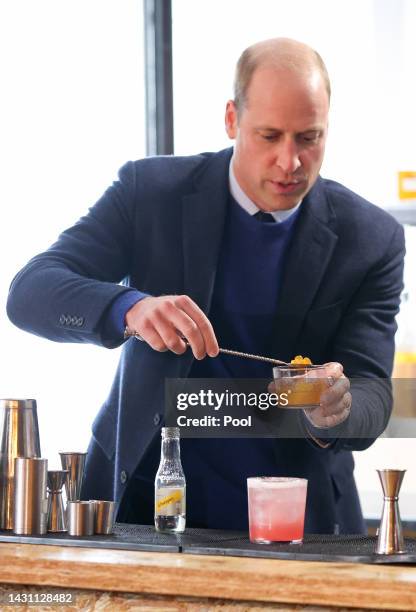 Prince William, Prince of Wales makes a cocktail as he visits the Trademarket outdoor market, as part of the royal visit to Northern Ireland on...