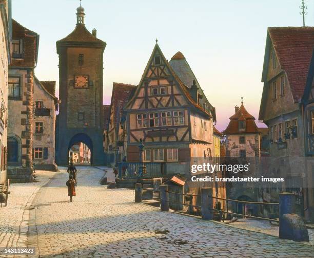 Rothenburg ob der Tauber. On the left and right the city gates "Sieberstor" and Kobolzellertor. Bavaria, germany. Hand-colored lantern slide around...