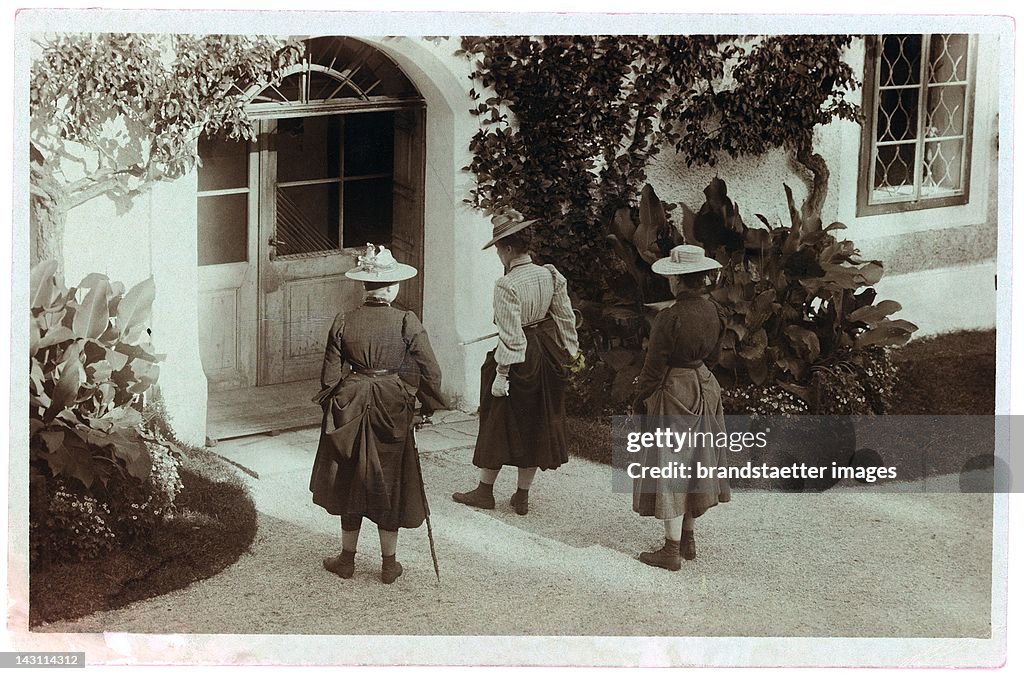 Three ladies wearing traditional hats