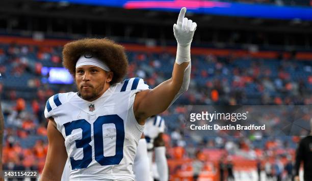 Phillip Lindsay of the Indianapolis Colts looks on during a game against the Denver Broncos at Empower Field At Mile High on October 06, 2022 in...