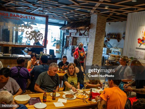 Pilgrims are seen eating the famous octopus in the city of Melide, Galicia, after walking one of the last stages of the Camino de Santiago. On May...