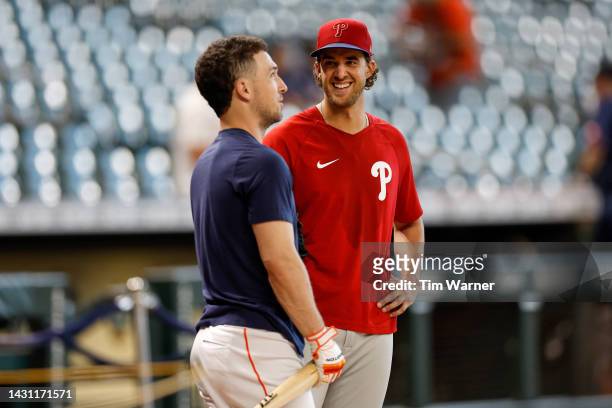 Aaron Nola of the Philadelphia Phillies talks with Alex Bregman of the Houston Astros before the game at Minute Maid Park on October 05, 2022 in...