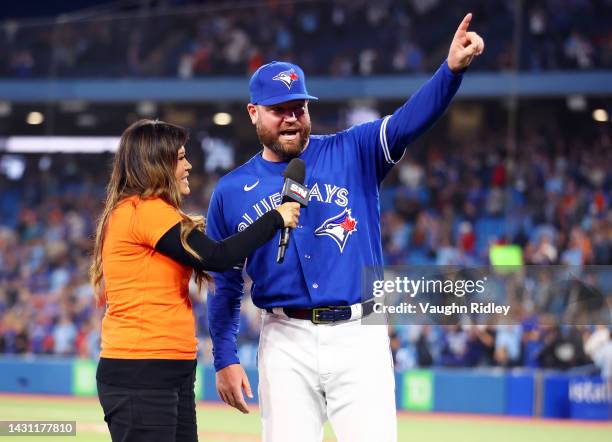 Manager John Schneider of the Toronto Blue Jays is interviewed by Hazel Mae after clinching a playoff spot following the win against the Boston Red...