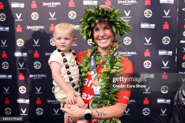 Chelsea Sodaro celebrates with her daughter Skylar after winning the Ironman World Championships on October 06, 2022 in Kailua Kona, Hawaii.