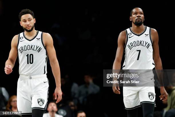 Ben Simmons and Kevin Durant of the Brooklyn Nets look on during the second half against the Miami Heat at Barclays Center on October 06, 2022 in the...