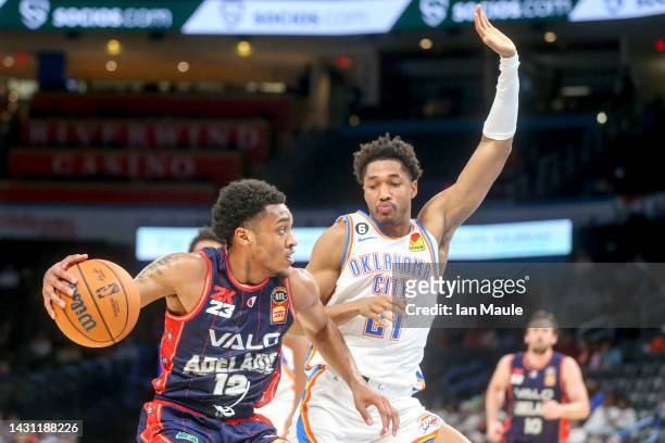 Craig Randall II of the Adelaide 36ers dribbles while Aaron Wiggins of the Oklahoma City Thunder defends during the second quarter at Paycom Center...