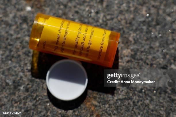 Pill bottles from a piñata are scattered on the sidewalk during a protest against the price of prescription drug costs in front of the U.S....