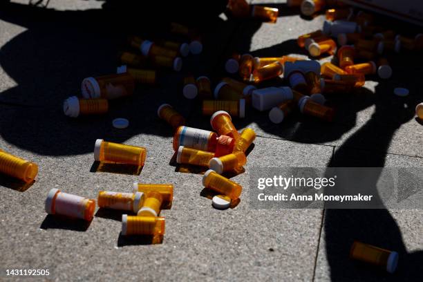 Pill bottles from a piñata are scattered on the sidewalk during a protest against the price of prescription drug costs in front of the U.S....