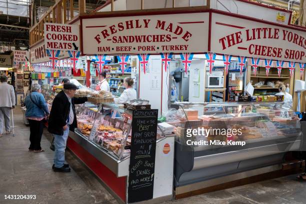 People and traders in the covered indoor market, Halifax Borough Market in the Albany Arcade on 6th June 2023 in Halifax, United Kingdom. Halifax is...