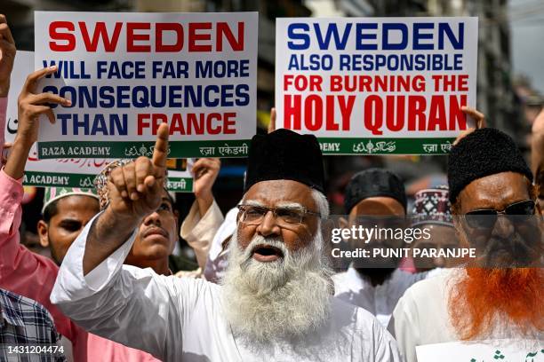 Muslim activists display placards as they shout anti-Sweden slogans during a protest against the burning of a Koran outside a Stockholm mosque, in...