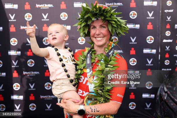 Chelsea Sodaro celebrates with her daughter Skylar after winning the Ironman World Championships on October 06, 2022 in Kailua Kona, Hawaii.