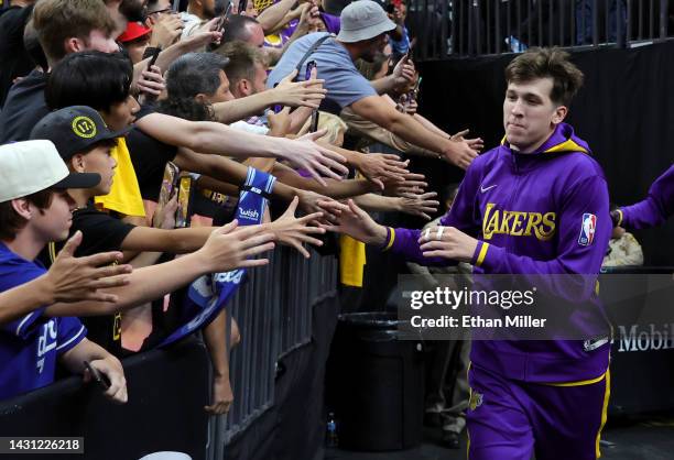 Austin Reaves of the Los Angeles Lakers is greeted by fans as he takes the court for warmups before a preseason game against the Minnesota...