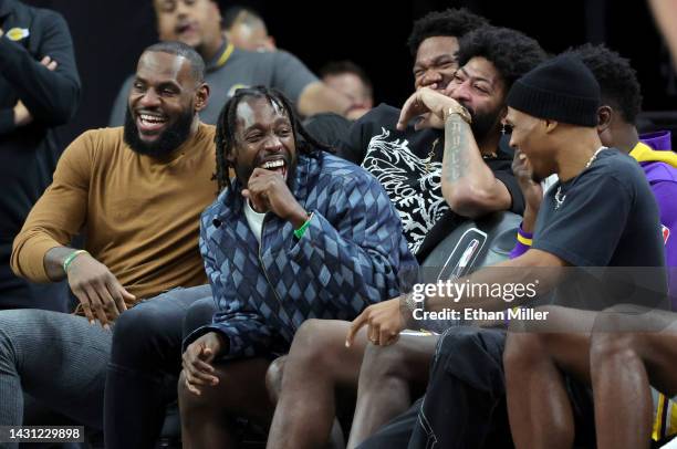 LeBron James, Patrick Beverley, Anthony Davis and Russell Westbrook of the Los Angeles Lakers laugh on the bench in the fourth quarter of a preseason...