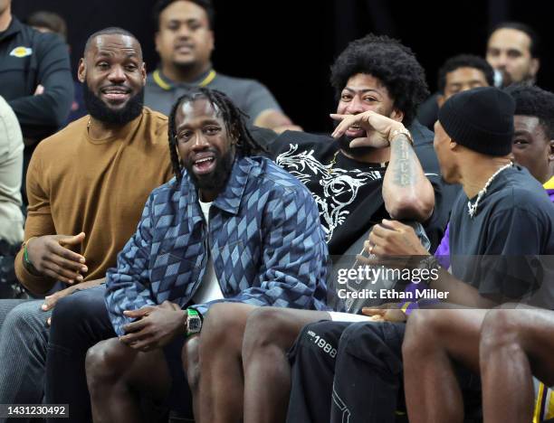 LeBron James, Patrick Beverley, Anthony Davis and Russell Westbrook of the Los Angeles Lakers laugh on the bench in the fourth quarter of a preseason...