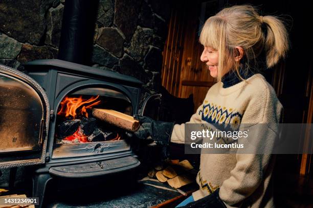 wood burning stove - warming up stock pictures, royalty-free photos & images