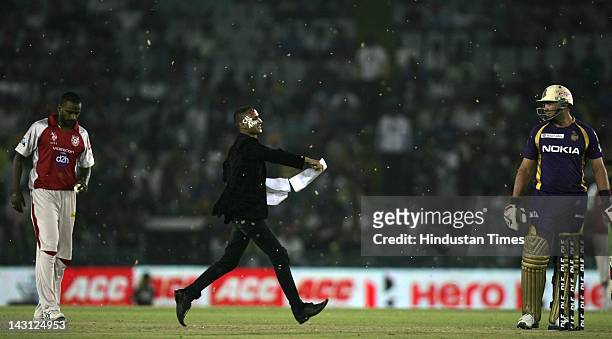 Pitch invader throws papers at a player during the IPL20 match between Kings XI Punjab and Kolkata Knight Riders at PCA cricket Stadium on April 18,...